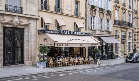 vintage bandw three friends at a paris cafe - 10 Famous Paris Cafes to Add to Your Parisian Bucket List.